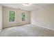 Spacious bedroom featuring neutral walls, carpet floors, and two windows providing natural light at 100 Julia Ct, Fayetteville, GA 30214