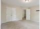 Bedroom featuring neutral walls, carpet floors, closet, and a door leading to hallway at 100 Julia Ct, Fayetteville, GA 30214