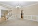 Formal dining room with neutral walls, carpeted floors, and elegant lighting for memorable gatherings at 100 Julia Ct, Fayetteville, GA 30214