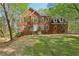 Two story brick home with well maintained lawn and beautiful mature trees in a quiet neighborhood at 100 Julia Ct, Fayetteville, GA 30214