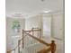 An upstairs hallway with carpet and wooden banister at 100 Julia Ct, Fayetteville, GA 30214