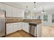 A kitchen with stainless steel dishwasher and white cabinets with granite countertops at 100 Julia Ct, Fayetteville, GA 30214