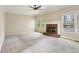 Large, bright living room with a traditional brick fireplace, ceiling fan, and carpeted floors for a comfortable living space at 100 Julia Ct, Fayetteville, GA 30214