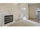 Living room featuring a cozy fireplace and double doors leading to another room at 100 Julia Ct, Fayetteville, GA 30214