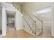 Elegant staircase with carpeted steps and hardwood floors in the entry, leading to the upper level at 100 Julia Ct, Fayetteville, GA 30214