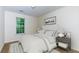 Bright bedroom features a neutral color scheme, a large window, and a comfortable queen-size bed at 137 Venture Path, Hiram, GA 30141