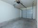 Spacious, empty single-car garage with a clean concrete floor and an automatic door opener at 137 Venture Path, Hiram, GA 30141