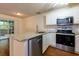 Well-lit kitchen features stainless steel appliances and granite countertops at 137 Venture Path, Hiram, GA 30141