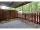 Cozy covered patio with a wooden fence, ideal for enjoying outdoor relaxation and privacy at 137 Venture Path, Hiram, GA 30141