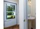 Powder room with pedestal sink and view to front door and lawn at 137 Venture Path, Hiram, GA 30141