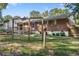 Lush backyard featuring a swing set, home exterior, and surrounding greenery at 37 Crystal River Dr, Riverdale, GA 30274