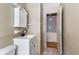 Compact bathroom featuring a modern vanity, toilet, and doorway to another room at 37 Crystal River Dr, Riverdale, GA 30274