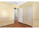Bedroom with yellow walls, hardwood flooring, a closet, and doorway to another room at 37 Crystal River Dr, Riverdale, GA 30274