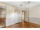 Bedroom featuring hardwood floors, neutral walls, a ceiling fan, and three doorways at 37 Crystal River Dr, Riverdale, GA 30274