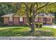 Charming single-story brick home featuring a well-maintained lawn and mature tree at 37 Crystal River Dr, Riverdale, GA 30274