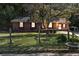 Quaint single-story brick home with a fenced yard, mature tree, and mailbox at 37 Crystal River Dr, Riverdale, GA 30274