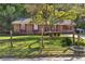 Quaint single-story brick home with a fenced yard, mature tree, and mailbox at 37 Crystal River Dr, Riverdale, GA 30274