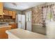 Bright kitchen featuring tiled wall accents, white appliances and eat-in dining area at 37 Crystal River Dr, Riverdale, GA 30274