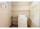Convenient laundry area featuring a washing machine, storage shelves, and natural light at 37 Crystal River Dr, Riverdale, GA 30274