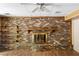 Inviting living room featuring a brick fireplace with wooden mantle and wood-look flooring at 37 Crystal River Dr, Riverdale, GA 30274