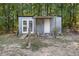 Backyard shed with double doors and additional entry point, nestled among the trees at 37 Crystal River Dr, Riverdale, GA 30274