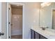 Bright bathroom features a double sink vanity with a marble countertop and a view of the tub and shower at 3835 Rifflepool Ct, Douglasville, GA 30135