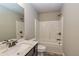 Bright bathroom features a single sink vanity with a marble countertop and a view of the tub and shower at 3835 Rifflepool Ct, Douglasville, GA 30135