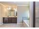 A luxurious bathroom features a double vanity, soaking tub, and tiled shower, bathed in natural light at 3835 Rifflepool Ct, Douglasville, GA 30135