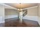 Dining room featuring dark hardwood floors and decorative trim at 3835 Rifflepool Ct, Douglasville, GA 30135