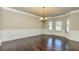 Formal dining room featuring hardwood floors, decorative chair rail, and modern lighting at 3835 Rifflepool Ct, Douglasville, GA 30135