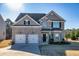 Charming brick home with a well-manicured lawn, two car garage, and a welcoming entrance at 3835 Rifflepool Ct, Douglasville, GA 30135