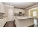 The kitchen features an island, stainless steel appliances, stylish white cabinets and attractive backsplash at 3835 Rifflepool Ct, Douglasville, GA 30135