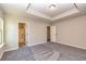 Spacious main bedroom includes a tray ceiling and an ensuite bathroom with tub and shower at 3835 Rifflepool Ct, Douglasville, GA 30135