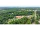 Aerial view shows homes situated in a lush wooded neighborhood at 6120 Hutchins Dr, Buford, GA 30518