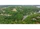Beautiful aerial view of a wooded community with lake access and docks at 6120 Hutchins Dr, Buford, GA 30518