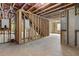 Unfinished basement with wooden framing, showcasing plumbing and electric, ready to be finished at 6120 Hutchins Dr, Buford, GA 30518