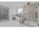 Luxurious bathroom featuring a freestanding tub, large shower with glass surround, and marble floors at 6120 Hutchins Dr, Buford, GA 30518