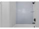 Modern bathroom with gray and white tiled shower and glass door featuring a black shower head and faucet at 6120 Hutchins Dr, Buford, GA 30518