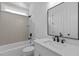 Modern bathroom featuring a combination tub and shower, white vanity, and contemporary fixtures and tiling at 6120 Hutchins Dr, Buford, GA 30518
