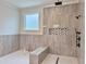 Modern bathroom featuring dual shower heads and a built-in bench, epitomizing luxury at 6120 Hutchins Dr, Buford, GA 30518