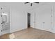 Bright bedroom featuring wood floors, a bathroom, walk-in closet, and neutral walls, creating a versatile space at 6120 Hutchins Dr, Buford, GA 30518