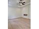 Spacious bedroom with light hardwood floors, recessed lighting, and modern trim at 6120 Hutchins Dr, Buford, GA 30518