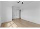 Well-lit bedroom boasts wood floors, white walls, and neutral accents, creating a serene and inviting space at 6120 Hutchins Dr, Buford, GA 30518
