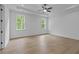 Spacious bedroom features hardwood floors, recessed lighting, and a ceiling fan at 6120 Hutchins Dr, Buford, GA 30518