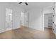 Bright bedroom featuring wood floors, a bathroom, walk-in closet, and neutral walls, creating a versatile space at 6120 Hutchins Dr, Buford, GA 30518
