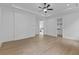 Bright and airy bedroom with tray ceiling, hardwood floors, and doorways to bathroom and closet at 6120 Hutchins Dr, Buford, GA 30518