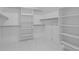 Walk-in closet features marble floor and custom shelving at 6120 Hutchins Dr, Buford, GA 30518