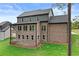 Rear exterior of brick home with patio and deck overlooking the backyard at 6120 Hutchins Dr, Buford, GA 30518