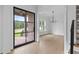 Elegant foyer featuring hardwood floors, a modern chandelier, and a stylish black metal door at 6120 Hutchins Dr, Buford, GA 30518