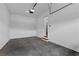 Well-lit garage with concrete floors, pedestrian door and interior access to the home at 6120 Hutchins Dr, Buford, GA 30518